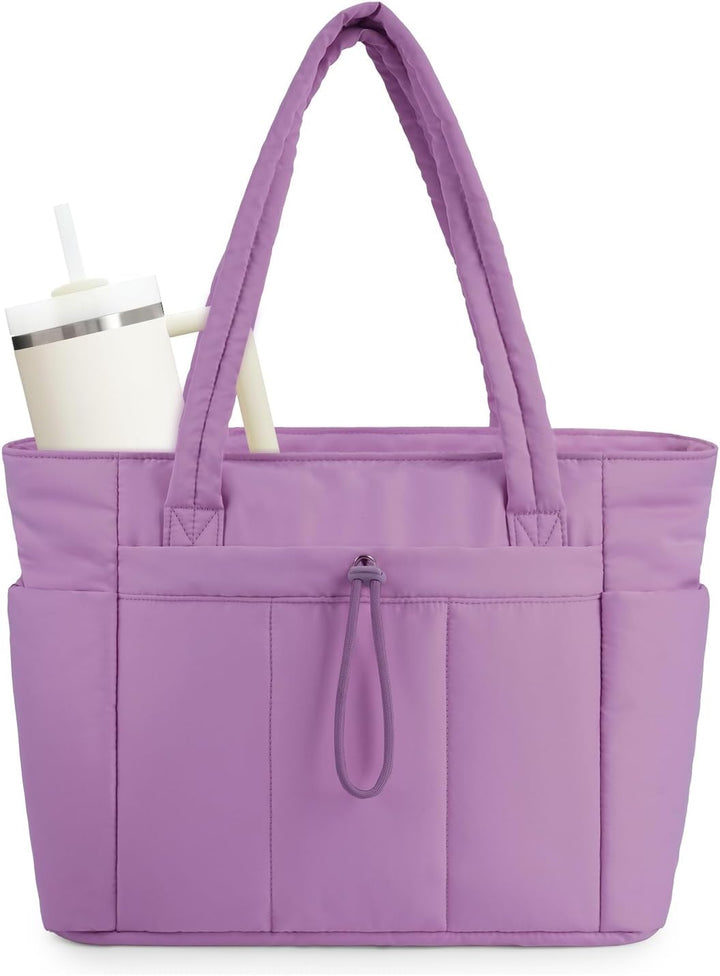 Quilted puffer tote next to a laptop, illustrating the perfect fit in its sleeve