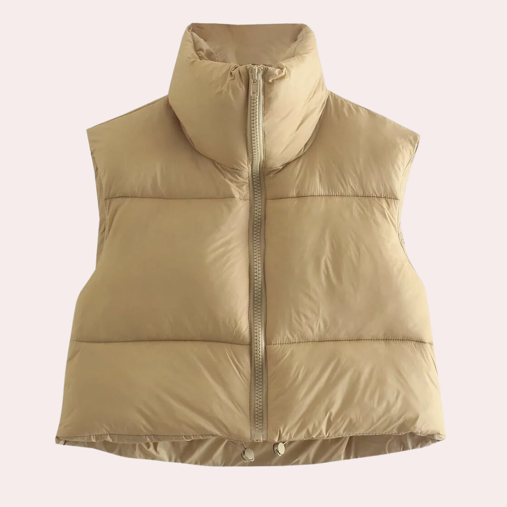 Women's quilted short bodywarmer vest for stylish layering. Lightweight polyester outerwear, perfect for fashion.