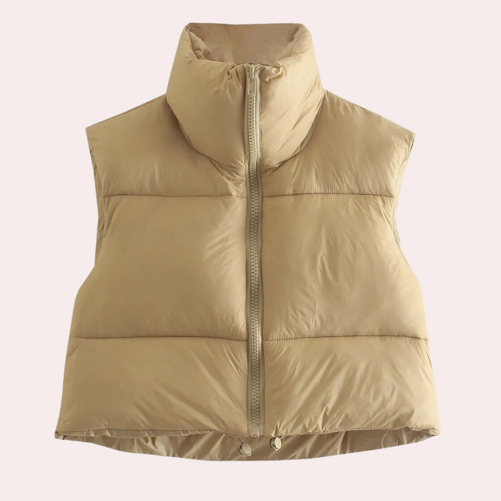 Women's quilted short bodywarmer vest for stylish layering. Lightweight polyester outerwear, perfect for fashion.