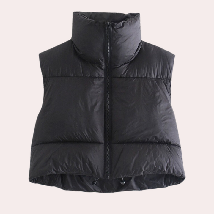 Front view of a women's short quilted gilet. Lightweight polyester outerwear, ideal for layering and versatile fashion.