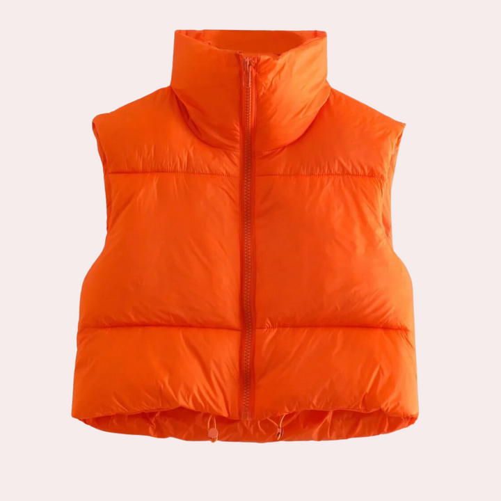 Detail of the quilted texture on a women's short bodywarmer vest. Comfortable polyester fabric for fashionable outerwear.
