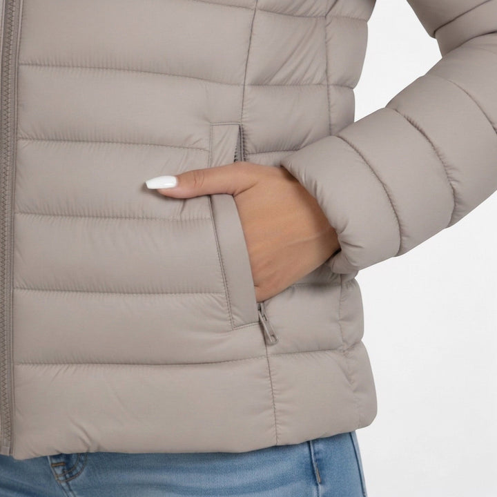 Woman wearing a slim fit quilted jacket with stand collar. Ideal for layering & casual fall fashion.