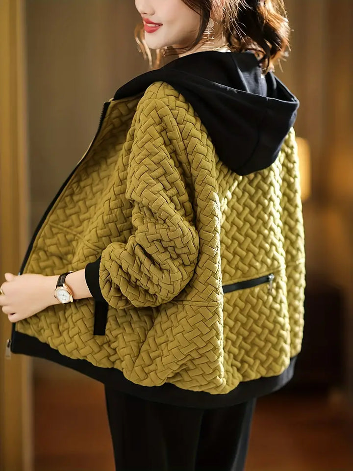 Women's quilted zip-up hoodie in cozy basketweave fabric, perfect for stylish fall and winter layering.