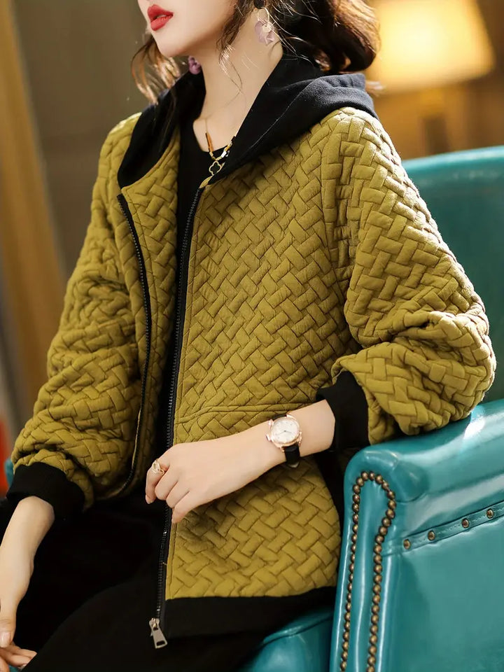 Cozy women's quilted zip-up hoodie offering winter warmth and fall fashion appeal, hooded design.