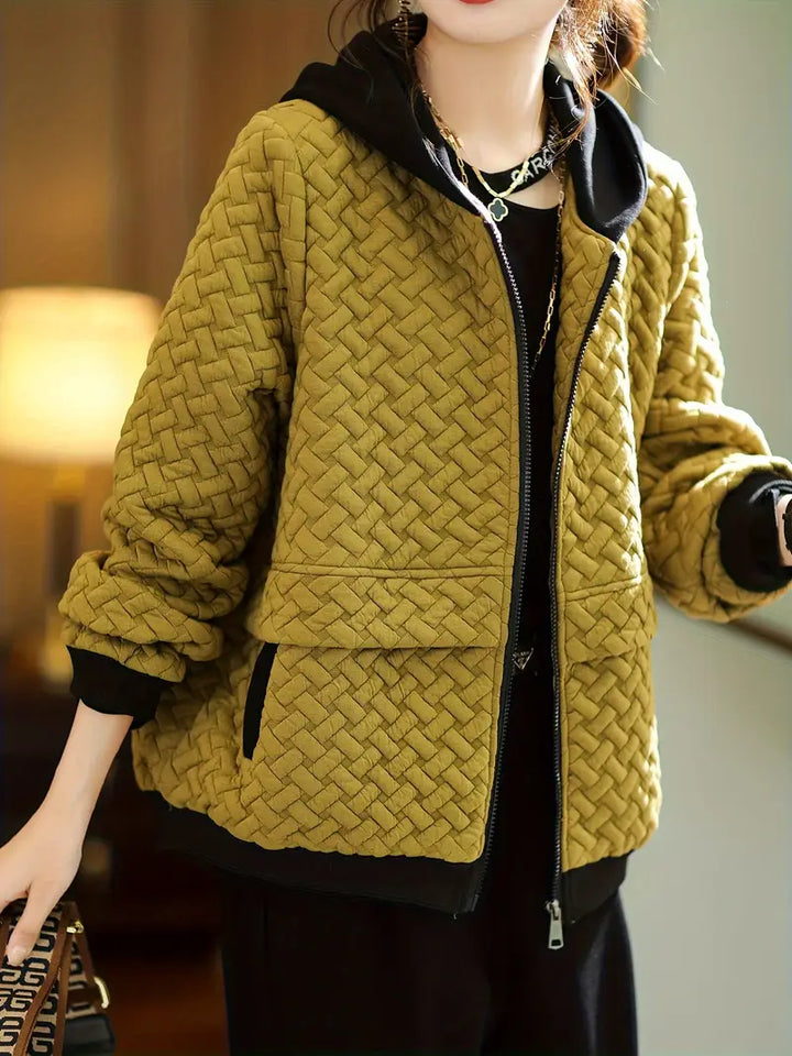 Close-up of the basketweave quilted texture on a women's cozy zip-up hoodie, soft and warm.