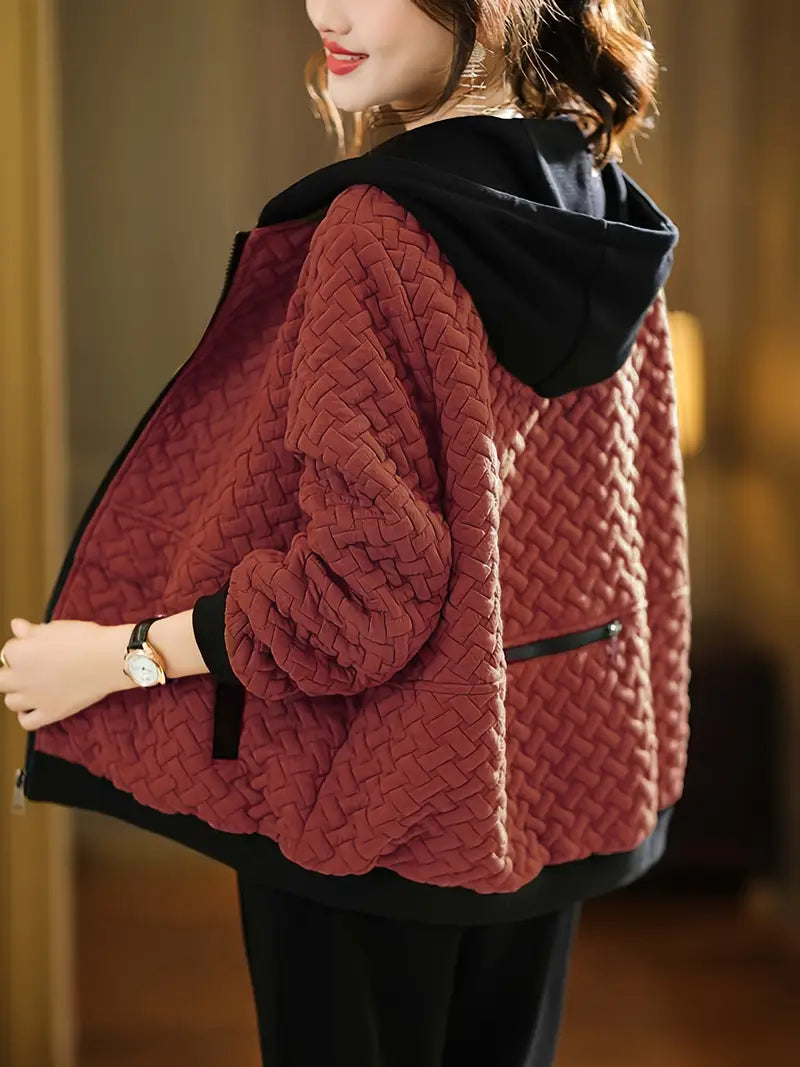 Woman wearing a full-zip quilted hoodie, a versatile and comfortable outerwear for women.