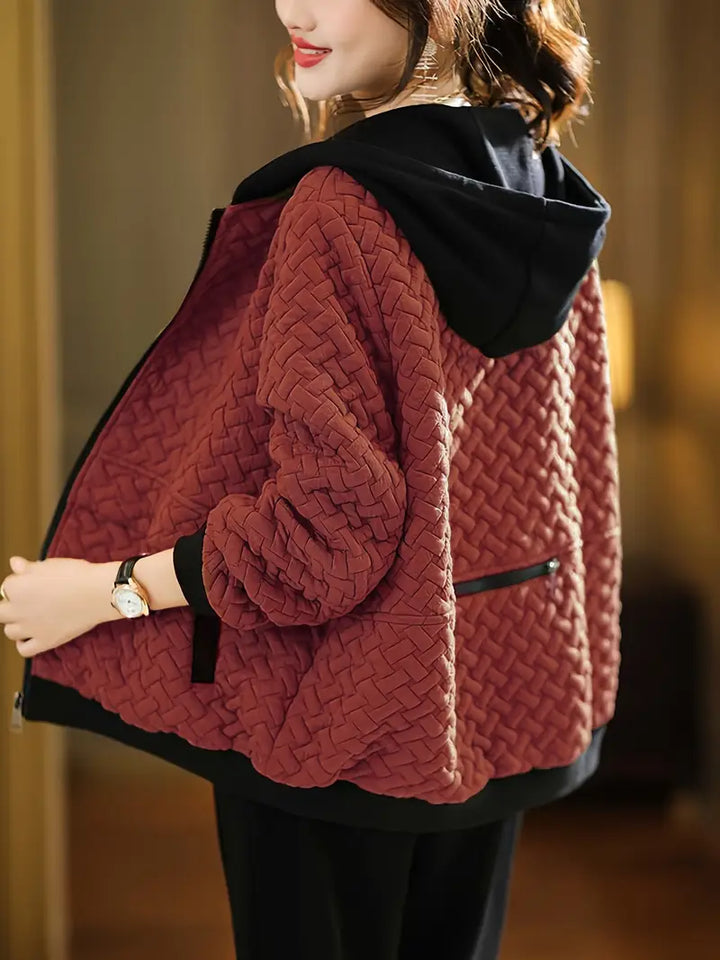Woman wearing a full-zip quilted hoodie, a versatile and comfortable outerwear for women.