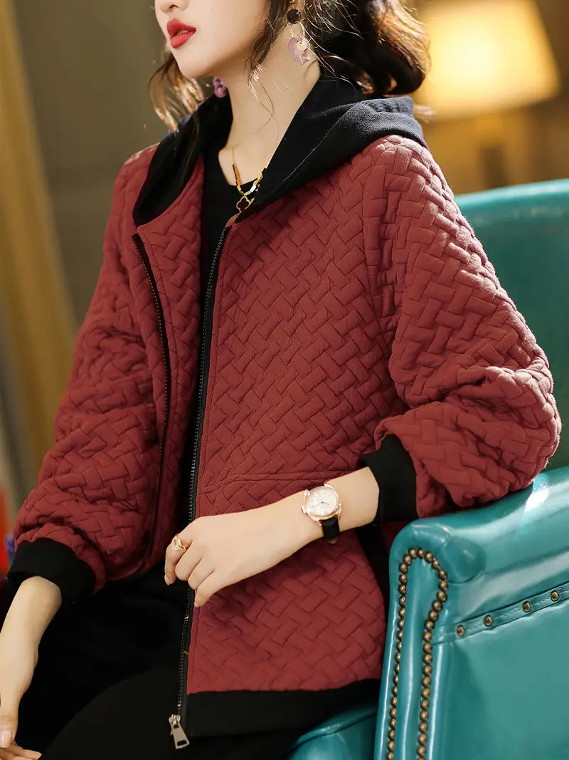 Women's quilted zip-up hoodie, an ideal layering piece for adding warmth and style to any outfit.