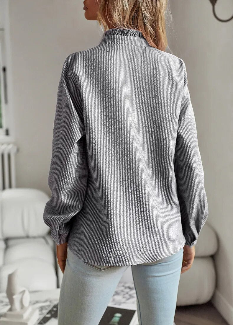 Long sleeve women's blouse with vibrant rebel style print & trendy mullet hem, unique fashion.