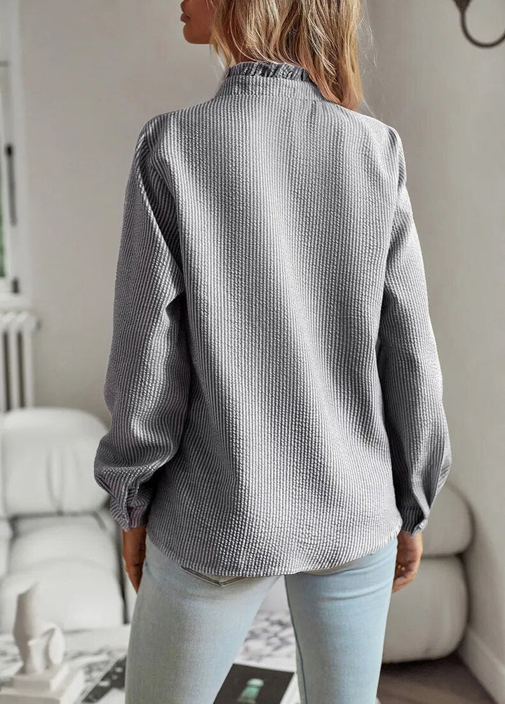 Long sleeve women's blouse with vibrant rebel style print & trendy mullet hem, unique fashion.