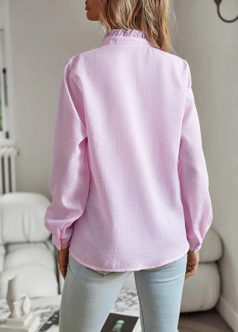 Women's long sleeve blouse, vibrant rebel style print with a bold fashion mullet hem.