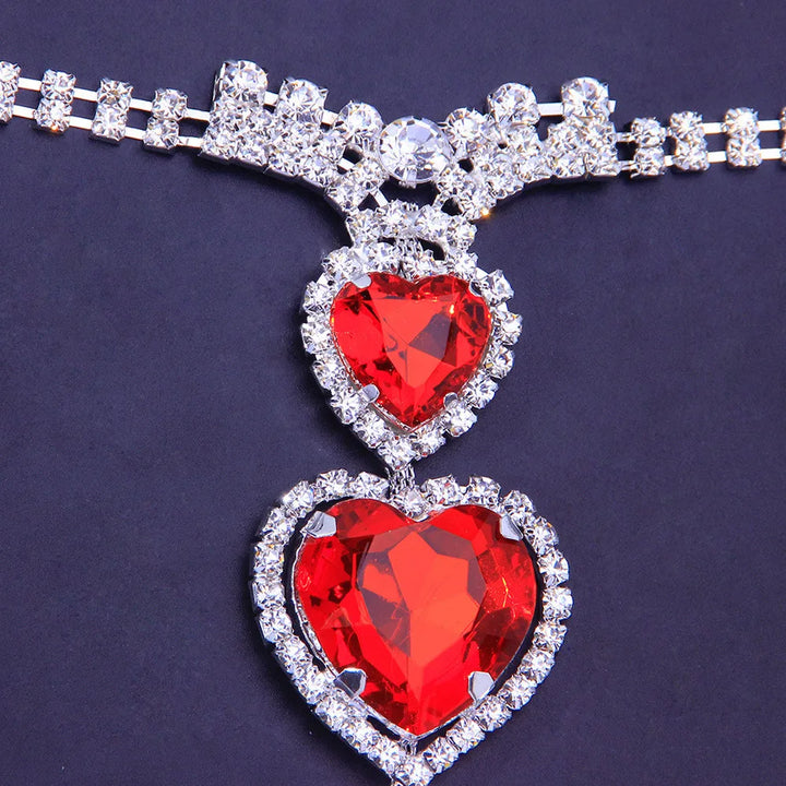 Stylish women's red heart rhinestone body chain for intimate wear. Crystal jewelry accessory.