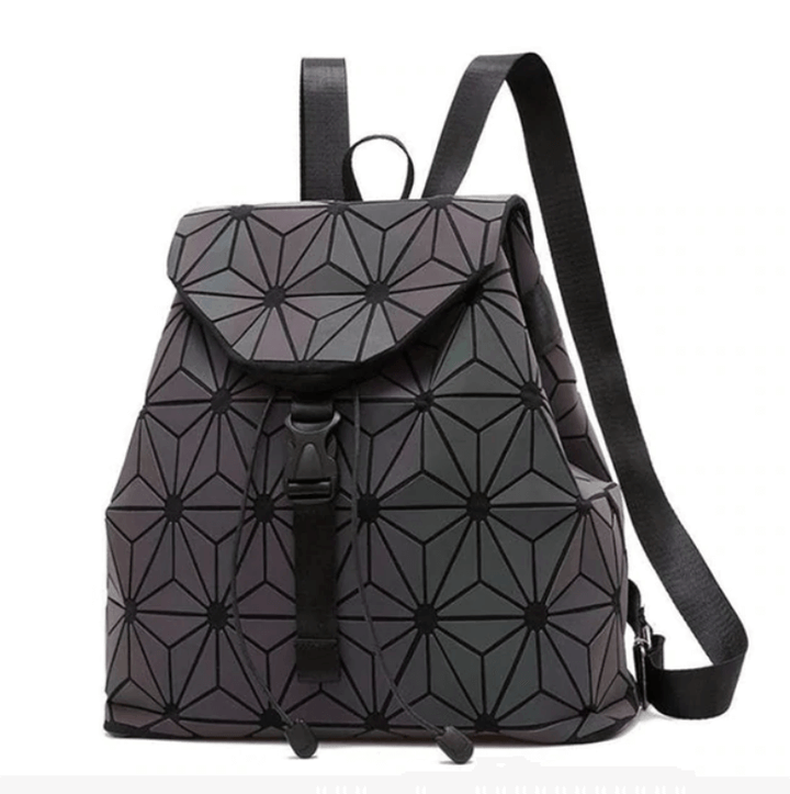 Reflective geometric backpack for women, showcasing its luminous effect and modern design