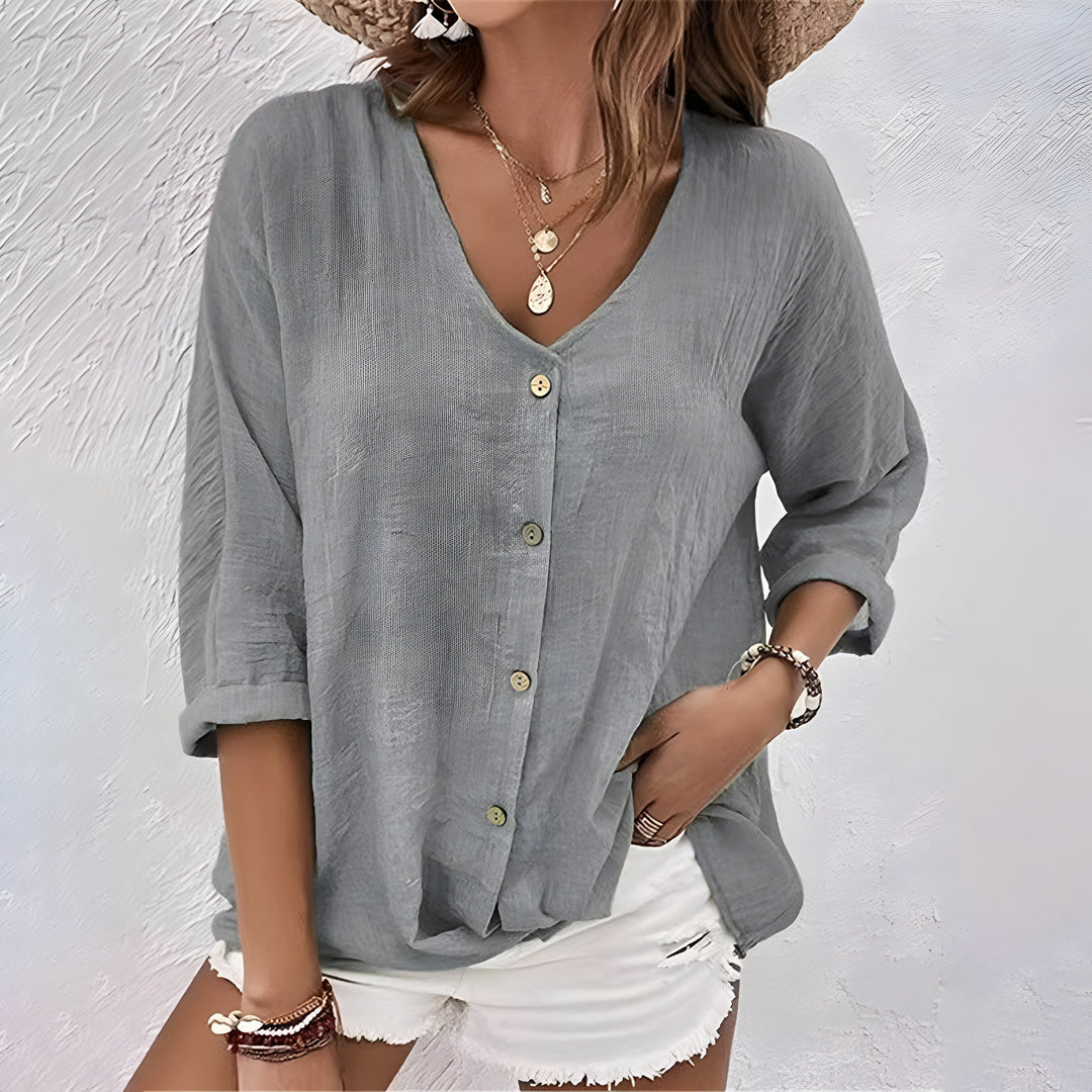 Stylish women's button-up blouse for office wear or casual outings. Relaxed fit, long sleeve, sophisticated.