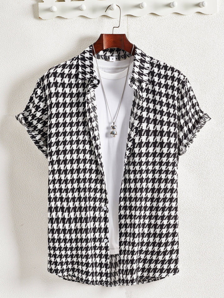 Women's relaxed fit button-up shirt in a classic houndstooth pattern. Long sleeve cotton blend top.