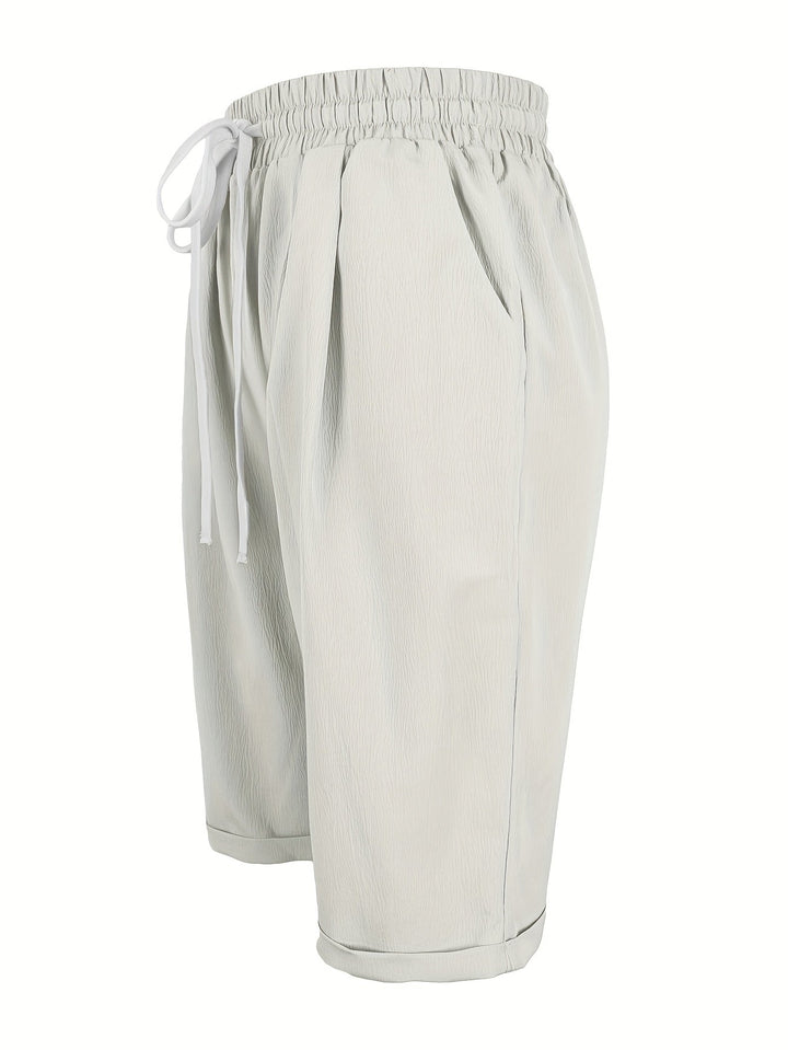 Relaxed fit women's capri trousers with a comfy elastic waist. Lightweight fabric, perfect for warm weather.