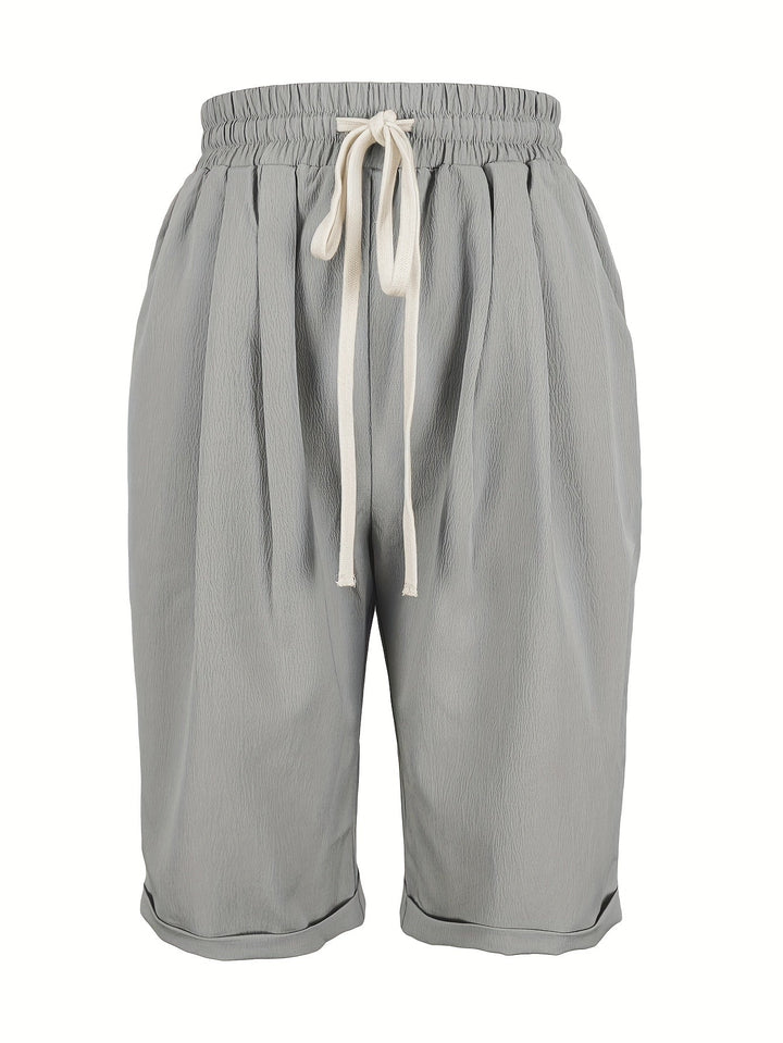 Woman wearing comfortable, lightweight relaxed fit capri trousers with elastic waist, ideal for summer.