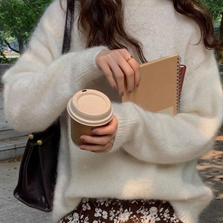 Comfortable women's long-sleeve pullover sweater with drop shoulders and a relaxed fit, made from durable, soft fabric.