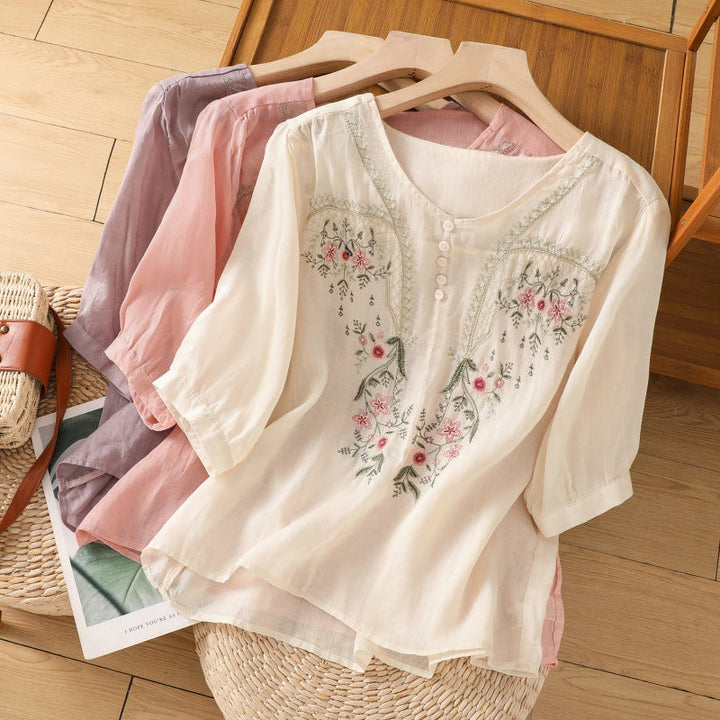 Women's relaxed fit floral embroidered blouse with long sleeves and a V-neck, perfect for spring casual wear.