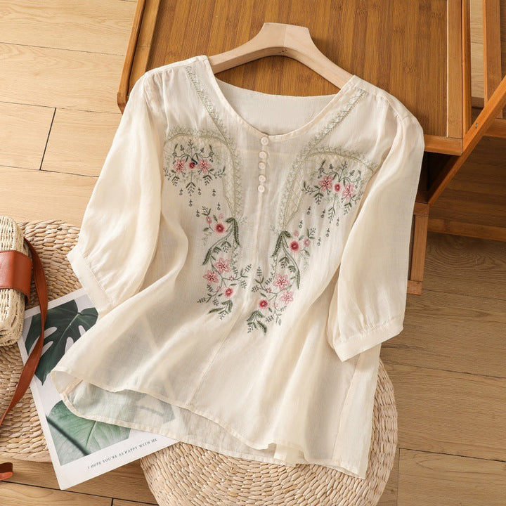 V-neck floral embroidered women's blouse with long sleeves, offering a relaxed fit for an elegant casual look.