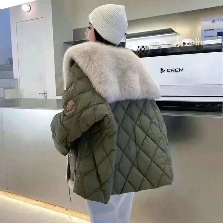 Warm women's relaxed fit jacket with luxurious fur collar from behind. Elegant long sleeve outerwear, ideal for winter.
