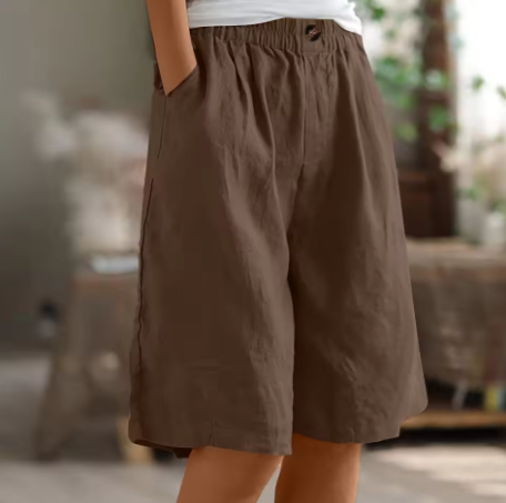 Model wearing women's relaxed high-waisted Bermuda shorts for ultimate summer comfort.