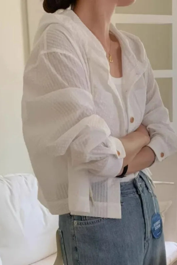 Close-up of lightweight fabric on a women's relaxed fit hooded blouse, ideal for summer comfort.