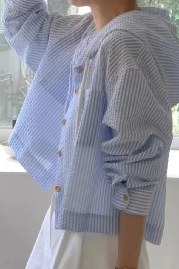 Women's relaxed fit hooded blouse, a lightweight long-sleeve top perfect for travel and effortless summer style.