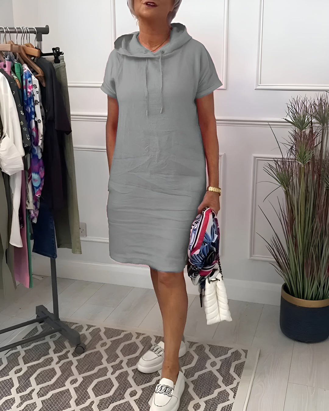 Chic women's relaxed fit hoodie midi dress with adjustable hood, perfect for casual comfort and everyday.