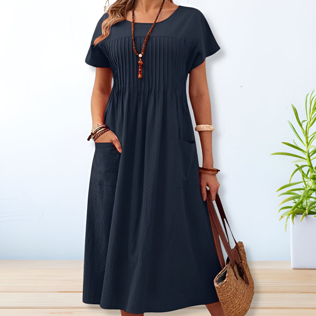 Effortless women's midi day dress. Comfortable relaxed fit, short sleeves, & pockets for casual summer wear.