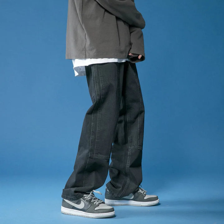 Trendy black women's oversized jeans with panel stitching, perfect for a modern relaxed fit and street style.