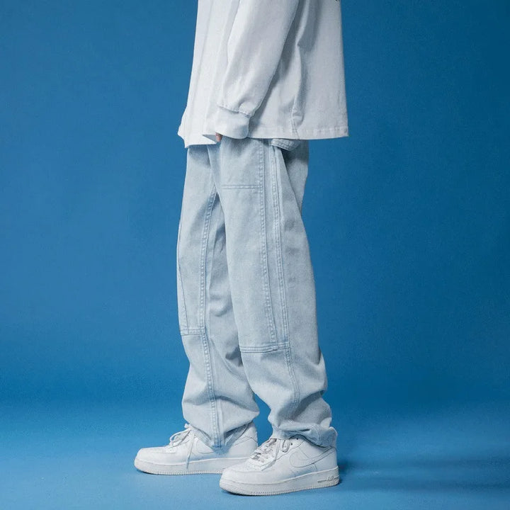 Women's modern blue oversized jeans, showcasing panel stitching and a comfortable relaxed fit for trendy fashion.