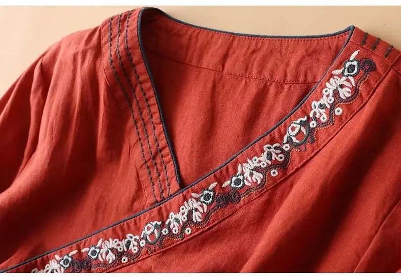 Navy blue patterned v-neck blouse. Elegant women's relaxed fit top.