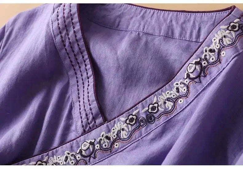 Navy blue patterned women's blouse. Relaxed fit v-neck, elegant spring fashion.