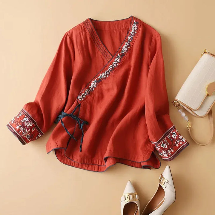 Chic pink patterned v-neck blouse. Women's relaxed fit, ideal for elegant spring fashion.