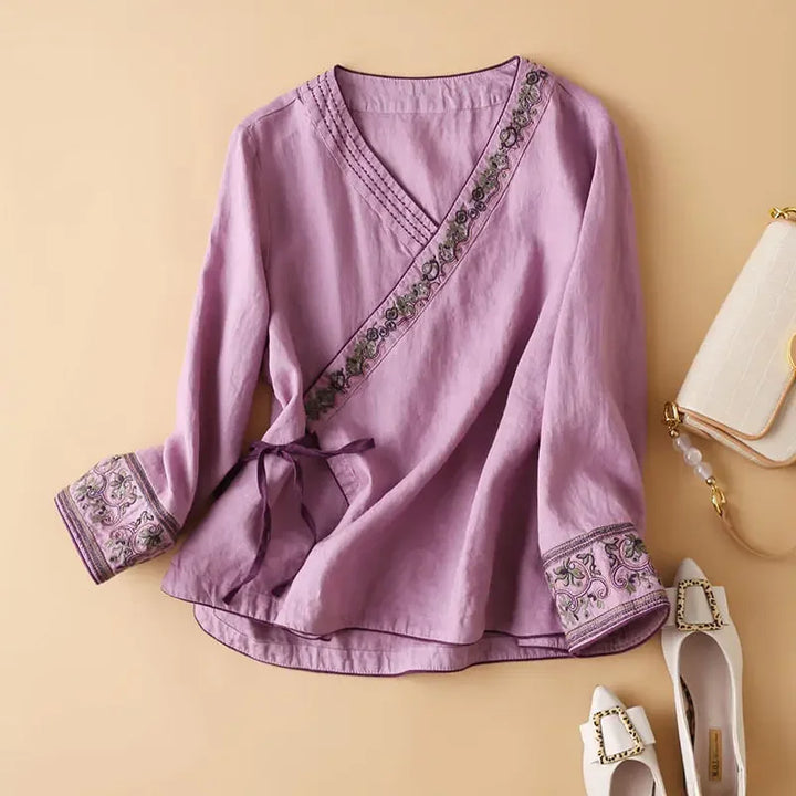 Elegant patterned v-neck blouse. Women's relaxed fit top, perfect for spring fashion.