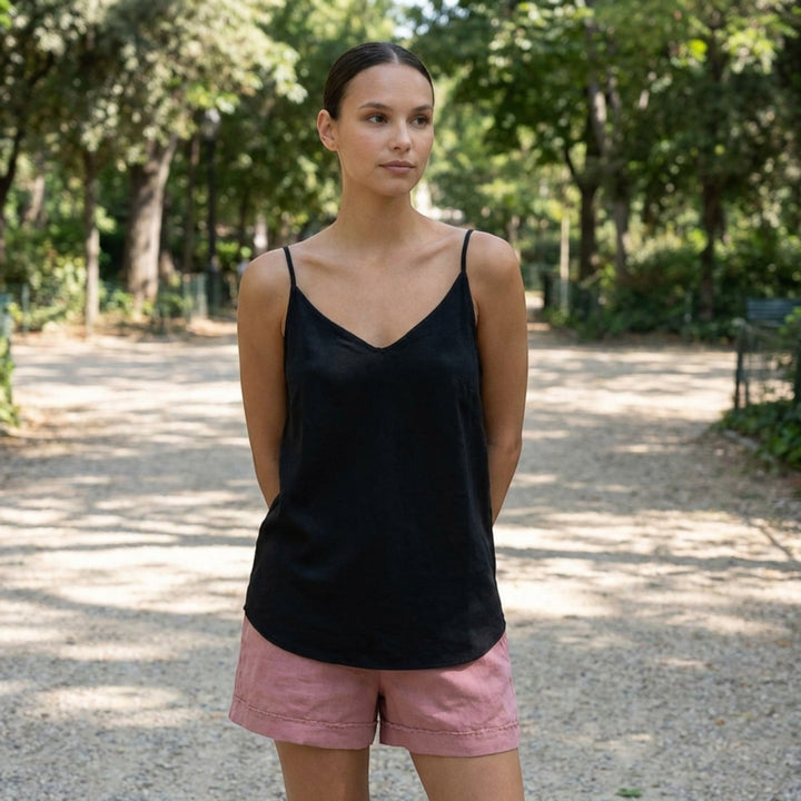 Sleeveless women's relaxed tank top with delicate spaghetti straps for summer style.