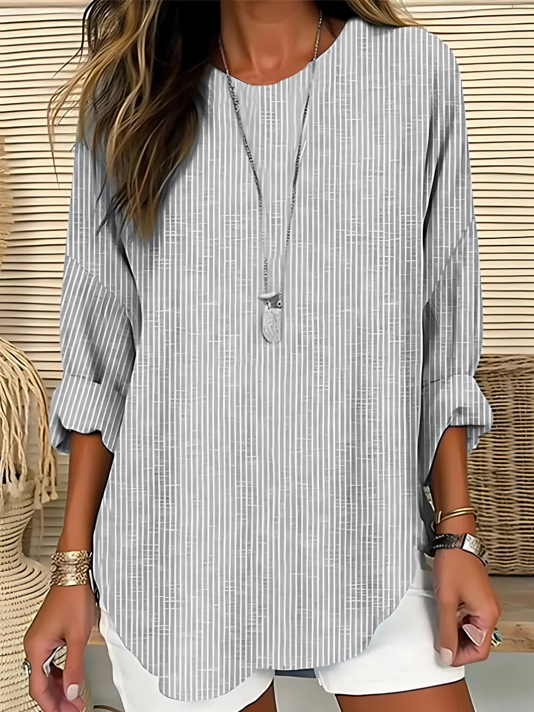 Relaxed fit women's striped long sleeve blouse with a round neck, ideal for versatile casual everyday fashion.