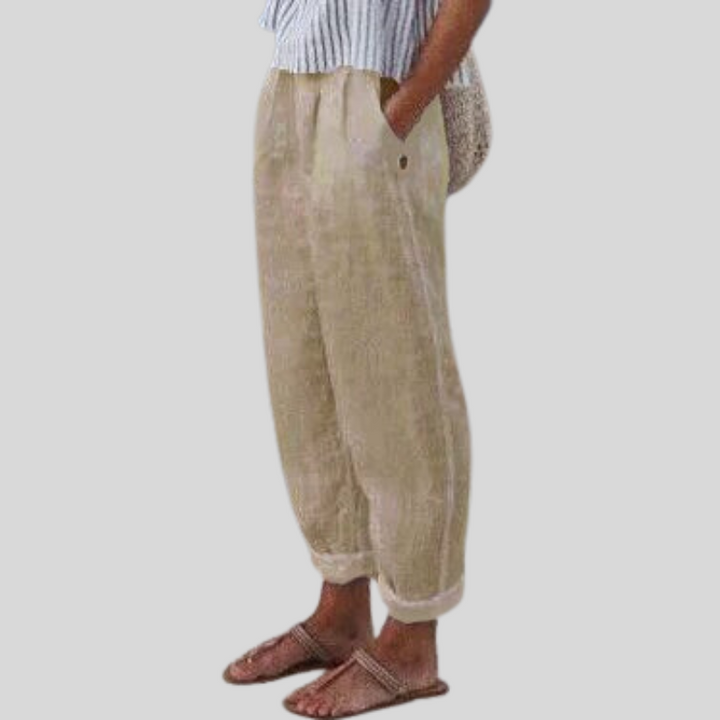 Women's relaxed fit trousers with stylish folded hem, perfect for summer comfort and casual elegance.