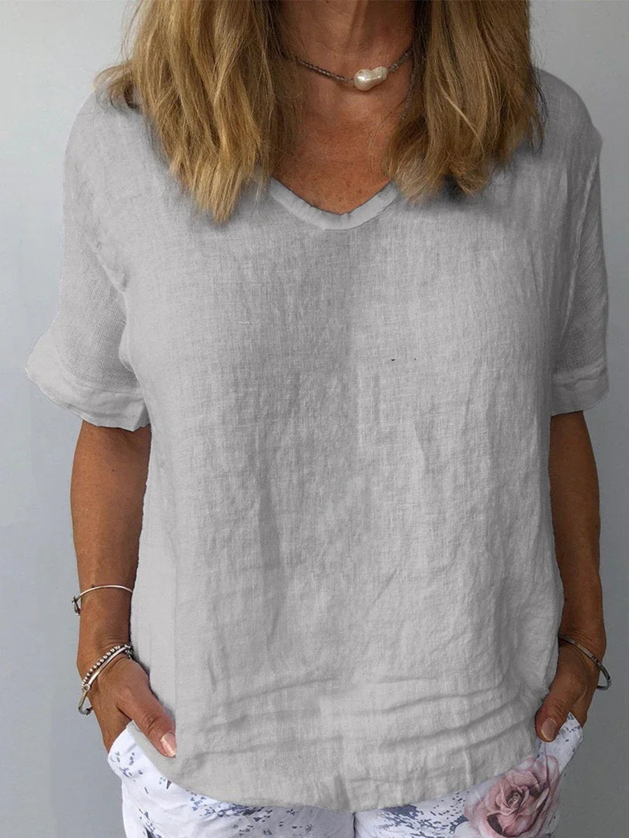 Versatile women's V-neck blouse, relaxed fit, short sleeve, great for casual everyday fashion.