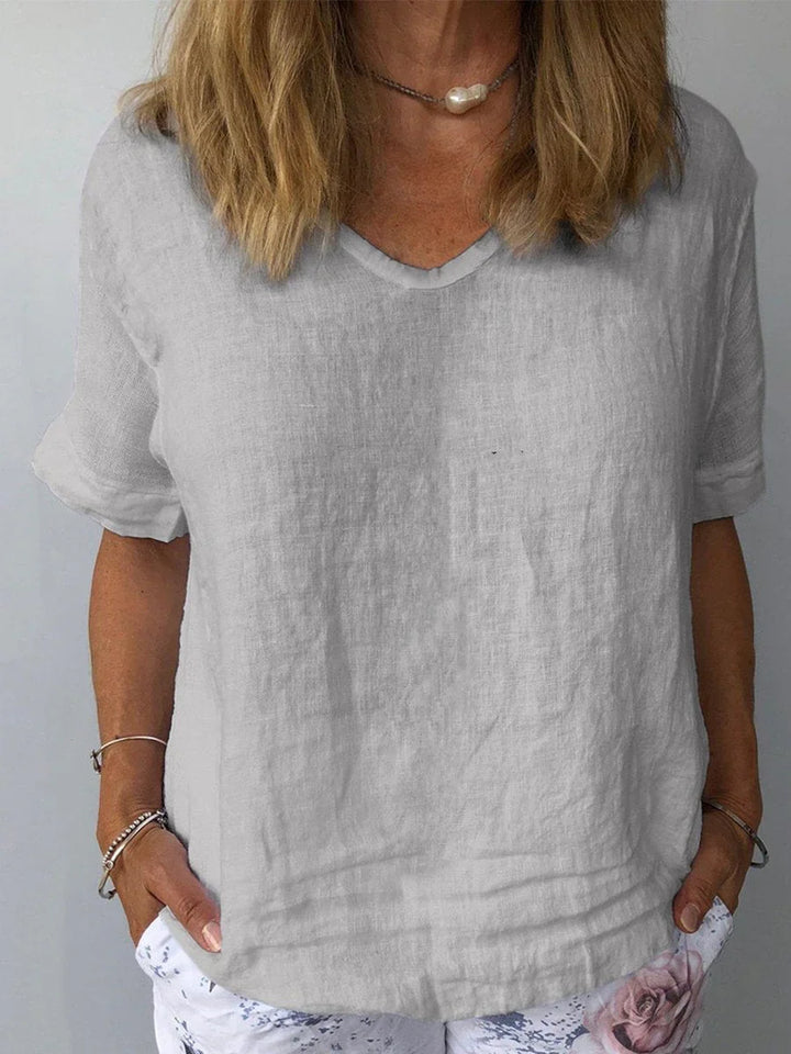 Versatile women's V-neck blouse, relaxed fit, short sleeve, great for casual everyday fashion.