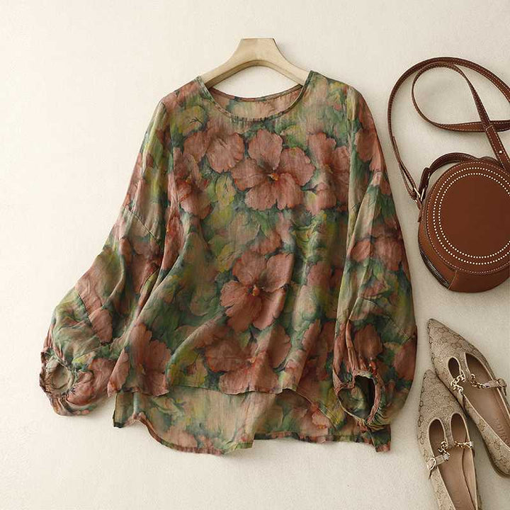 Women's relaxed fit watercolor floral blouse in airy fabric, elegant long sleeve top for spring & summer style.