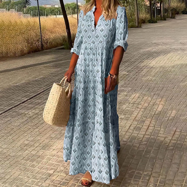 Flowy bohemian style women's maxi dress. Features a relaxed V-neck and vibrant all-over boho print.
