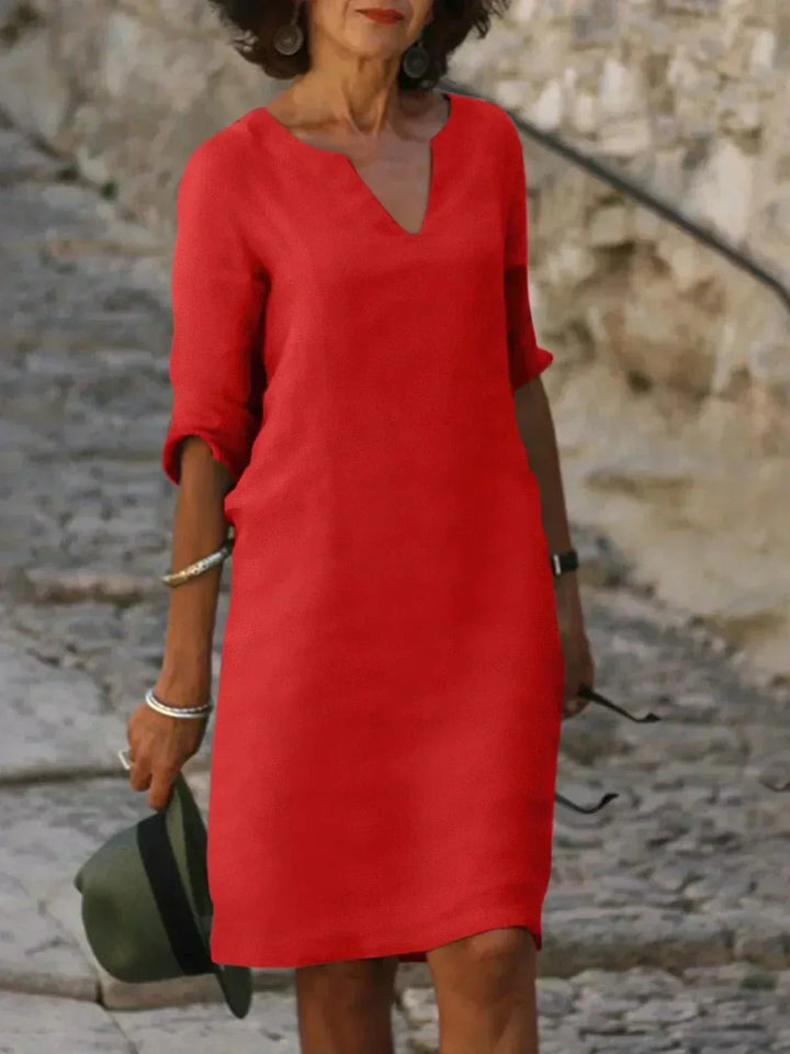 Women's relaxed V-neck dress with pockets, a stylish and practical midi for summer casual.