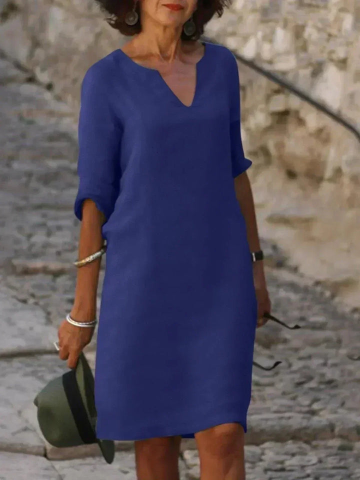 Relaxed fit women's V-neck midi dress, comfortable & stylish option for versatile everyday wear.