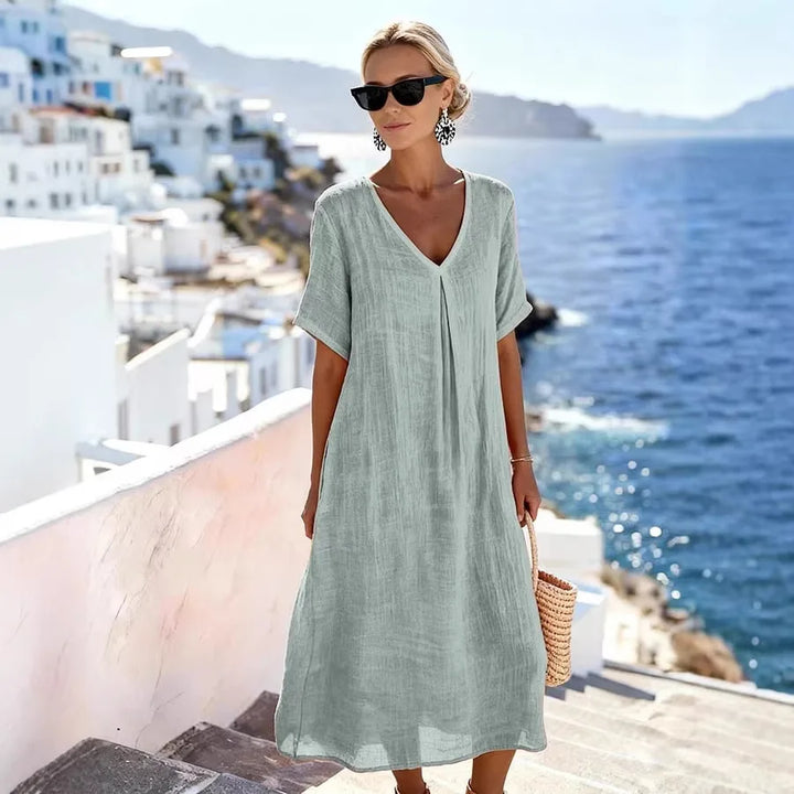 Stylish women's V-neck midi dress, relaxed fit & short sleeves. A go-to for summer and casual events.