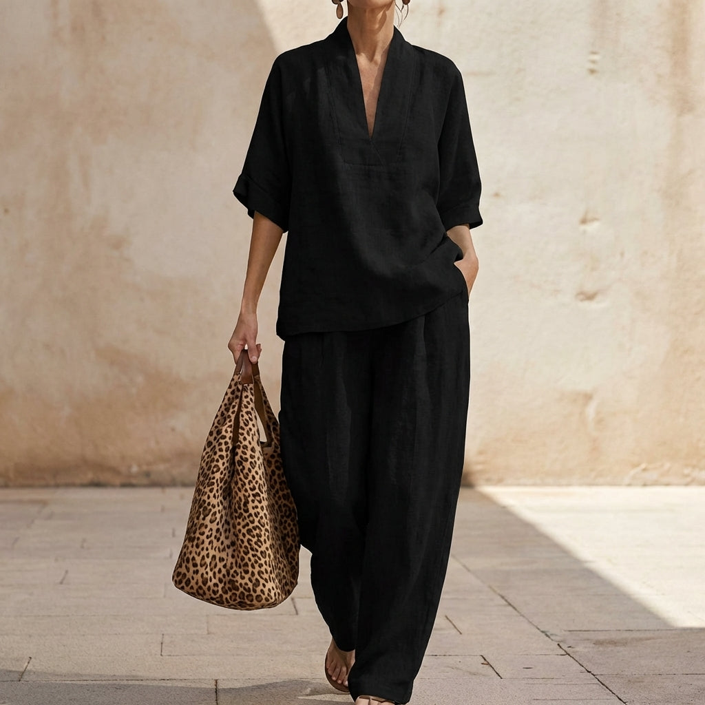 Stylish women's V-neck top & wide-leg pants matching set. Casual chic two-piece outfit for a relaxed elegant look.