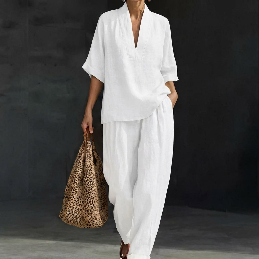 Elegant women's relaxed V-neck top and flowy wide-leg pants set. A comfortable and stylish two-piece travel outfit.