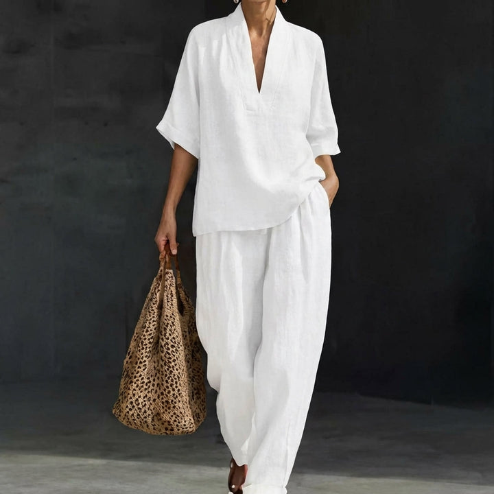 Elegant women's relaxed V-neck top and flowy wide-leg pants set. A comfortable and stylish two-piece travel outfit.