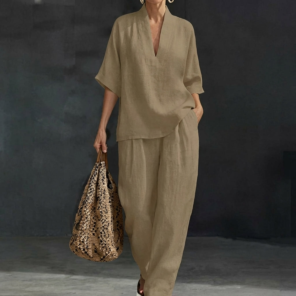 Full-body view of a women's relaxed V-neck top & wide-leg pants set. Matching two-piece outfit for casual style.